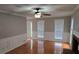 Spacious living room with hardwood floors, a fireplace, and natural light from multiple windows at 1511 Harbor Watch Ct, Woodstock, GA 30189