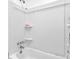 Bathroom with a white tub and shower with built-in shelves for toiletries and supplies at 1563 Greenwood Dr, Norcross, GA 30093