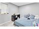 Cozy bedroom with tile floors, window, a small shelf, and comfy bed with blue and white striped sheets at 1563 Greenwood Dr, Norcross, GA 30093