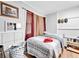 Modest bedroom with wood floors, neutral tones and a single window for natural light at 1563 Greenwood Dr, Norcross, GA 30093