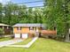 Charming home featuring brick accents, a two-car garage, and a welcoming entrance in a lush, green setting at 1563 Greenwood Dr, Norcross, GA 30093