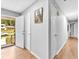 Bright hallway featuring wood floors and access to the exterior at 1563 Greenwood Dr, Norcross, GA 30093