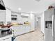 Kitchen with tile floors, white cabinets, stainless steel fridge and a window with natural light at 1563 Greenwood Dr, Norcross, GA 30093