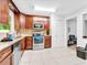 Well-lit kitchen featuring granite countertops, stainless steel appliances, and ample storage space at 1563 Greenwood Dr, Norcross, GA 30093