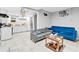 Living space with gray and blue sofas and a combined eat-in kitchen on ceramic tile flooring at 1563 Greenwood Dr, Norcross, GA 30093
