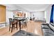Open-concept living room featuring wood floors, modern furnishings, and a seamless flow to the kitchen area at 1563 Greenwood Dr, Norcross, GA 30093