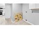 Empty room, light gray walls and beige ceramic tile floors. Canvas art leaning on the wall at 1563 Greenwood Dr, Norcross, GA 30093