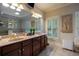 Elegant bathroom boasting dual vanities, a large mirror, and refined decorative elements at 3127 Lenox Ne Rd # 1, Atlanta, GA 30324
