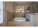 Modern bathroom featuring a tiled tub, glass shower, and a reflective mirrored wall at 3127 Lenox Ne Rd # 1, Atlanta, GA 30324