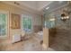 Elegant bathroom featuring a soaking tub, tiled shower, and natural light from the shuttered windows at 3127 Lenox Ne Rd # 1, Atlanta, GA 30324