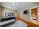 Bedroom featuring hardwood floors, an accent wall, and an ensuite bathroom at 3127 Lenox Ne Rd # 1, Atlanta, GA 30324