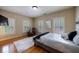 Bright bedroom featuring hardwood floors, a cozy leather chair, and shuttered windows at 3127 Lenox Ne Rd # 1, Atlanta, GA 30324