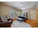 Bedroom featuring hardwood floors, a cozy leather chair, and shuttered windows at 3127 Lenox Ne Rd # 1, Atlanta, GA 30324