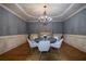 Formal dining area with a modern chandelier, hardwood floors, and elegant wainscoting at 3127 Lenox Ne Rd # 1, Atlanta, GA 30324