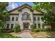 Elegant two-story home with a painted brick facade, balcony, and mature landscaping at 3127 Lenox Ne Rd # 1, Atlanta, GA 30324