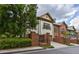 Side view of an elegant home showcasing a brick privacy wall and driveway at 3127 Lenox Ne Rd # 1, Atlanta, GA 30324