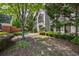 Beautiful home exterior with lush landscaping, mature trees, and manicured bushes at 3127 Lenox Ne Rd # 1, Atlanta, GA 30324