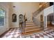 Spacious foyer featuring marble floors, a staircase with custom ironwork, and elegant archways at 3127 Lenox Ne Rd # 1, Atlanta, GA 30324