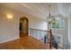Grand hallway features hardwood floors, elegant iron railing, chandelier, and arched doorways to other rooms at 3127 Lenox Ne Rd # 1, Atlanta, GA 30324