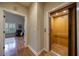 Hallway view of an elevator and an open doorway leading into a living room with hardwood floors and plantation shutters at 3127 Lenox Ne Rd # 1, Atlanta, GA 30324