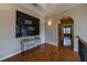 Elegant hallway features hardwood floors, stylish console table with modern art, and arched doorways to adjoining rooms at 3127 Lenox Ne Rd # 1, Atlanta, GA 30324