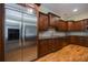 Stainless steel refrigerator and dark wood cabinetry in a well-lit kitchen with granite countertops at 3127 Lenox Ne Rd # 1, Atlanta, GA 30324