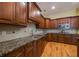 A kitchen with wooden cabinets, granite countertops, tile backsplash and stainless steel appliances at 3127 Lenox Ne Rd # 1, Atlanta, GA 30324