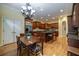 Well-lit kitchen features an island, hardwood floors, a table, and stainless steel appliances at 3127 Lenox Ne Rd # 1, Atlanta, GA 30324