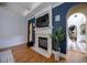 Living room with fireplace, mounted tv and adjacent arched entryway to stairs with tiled landing at 3127 Lenox Ne Rd # 1, Atlanta, GA 30324