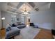 Bright living room featuring a tray ceiling, hardwood floors, and comfortable seating with natural light at 3127 Lenox Ne Rd # 1, Atlanta, GA 30324
