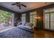 Stylish living room leading to an outdoor patio features hardwood floors, a gray sofa, and modern decor at 3127 Lenox Ne Rd # 1, Atlanta, GA 30324