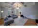 Bright living room featuring a tray ceiling, hardwood floors, and comfortable seating with natural light at 3127 Lenox Ne Rd # 1, Atlanta, GA 30324