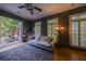 Stylish living room boasts dark walls, hardwood floors, with access to a brick patio through glass doors at 3127 Lenox Ne Rd # 1, Atlanta, GA 30324