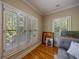 Sunlit living room featuring hardwood floors, plantation shutters, and a stylish gray sofa at 3127 Lenox Ne Rd # 1, Atlanta, GA 30324