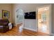Bright main bedroom boasts hardwood floors, plantation shutters, and a wall-mounted TV at 3127 Lenox Ne Rd # 1, Atlanta, GA 30324