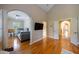 Spacious main bedroom features hardwood floors, a vaulted ceiling, arched entryway and a flat screen TV at 3127 Lenox Ne Rd # 1, Atlanta, GA 30324