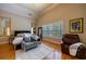 Spacious main bedroom with hardwood floors, a gray sofa, plantation shutters, and a vaulted ceiling at 3127 Lenox Ne Rd # 1, Atlanta, GA 30324