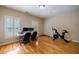 Office featuring hardwood floors, two windows, and an exercise bike at 3127 Lenox Ne Rd # 1, Atlanta, GA 30324