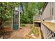 Secluded backyard featuring a small greenhouse, garden beds, and a charming stone patio area at 865 Ashland Ne Ave, Atlanta, GA 30307