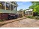 Landscaped backyard with stone patio, greenhouse, and unique architectural details at 865 Ashland Ne Ave, Atlanta, GA 30307