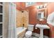 Bathroom features a pedestal sink, decorative lighting, and a combined tub and shower at 865 Ashland Ne Ave, Atlanta, GA 30307