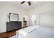 Spacious bedroom with hardwood floors, dresser, and doors leading to additional rooms at 865 Ashland Ne Ave, Atlanta, GA 30307