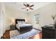 Cozy bedroom features a neutral color palette, plush bed, ceiling fan and hardwood floors at 865 Ashland Ne Ave, Atlanta, GA 30307