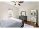 Bright bedroom with hardwood floors, dresser, and view into adjacent sunroom at 865 Ashland Ne Ave, Atlanta, GA 30307