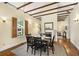 Traditional dining room with exposed beam ceiling, hardwood floors, and large window with shuttered blinds at 865 Ashland Ne Ave, Atlanta, GA 30307