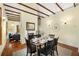 Dining room with exposed beam ceiling and hardwood floors open to living room at 865 Ashland Ne Ave, Atlanta, GA 30307