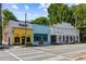 Exterior view of retail buildings, Revolution Doughnuts and Kadampa Meditation Center, diverse shopping options at 865 Ashland Ne Ave, Atlanta, GA 30307