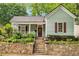 Charming home featuring stone retaining wall, inviting front porch, and meticulous landscaping at 865 Ashland Ne Ave, Atlanta, GA 30307