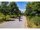 People enjoy biking and walking on a paved path surrounded by lush green trees and foliage at 865 Ashland Ne Ave, Atlanta, GA 30307