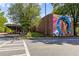 Brick building featuring a large mural of a Personal face, adding artistic flair to the neighborhood at 865 Ashland Ne Ave, Atlanta, GA 30307